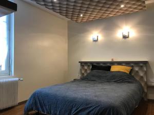 - une chambre avec un lit et deux lumières sur le mur dans l'établissement citesteloi, à Friville-Escarbotin