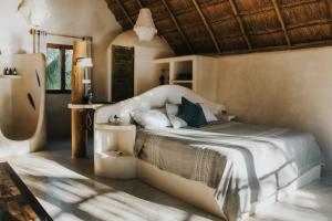 a bedroom with a large bed in a room at Zorba Tulum Beach Homes in Tulum