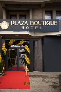 a hotel entrance with a red carpet and a sign at Plaza Boutique Hotel in Pristina