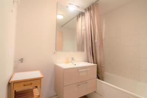 a white bathroom with a sink and a mirror at CABANA & Voie Verte - Parking, Terrasse, Lac in Saint-Jorioz