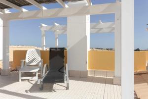 eine Terrasse mit zwei Stühlen auf dem Dach in der Unterkunft Apartamento Maresia T2 Penthouse by Your Home Algarve in Cabanas de Tavira