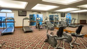 a gym with several treadmills and elliptical machines at Camino Real Puebla Angelopolis in Puebla