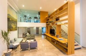 a living room with a staircase and a couch and a table at Camino Real Puebla Angelopolis in Puebla
