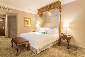 a hotel room with a large bed and a mirror at Quinta Real Monterrey in Monterrey +78 photos
