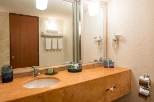 a bathroom with a sink and a large mirror at Camino Real Guadalajara in Guadalajara