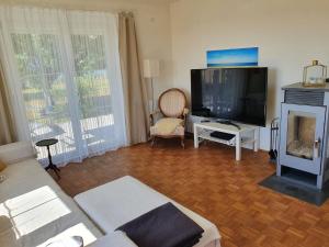 a living room with a couch and a television at Ferienhaus Kerschbaum in Wiener Neustadt in Wiener Neustadt