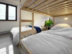 a bedroom with two bunk beds and a window at Pokoje Wczasowe Grzybowo in Grzybowo