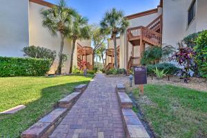 a brick path in front of a house with palm trees at Siesta Key Condo Resort Amenities, Walk to Beach! in Siesta Key