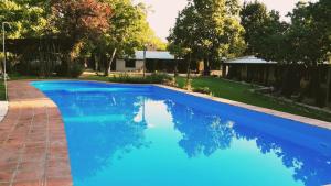 a swimming pool with blue water in a yard at Gardenia Select in San Javier