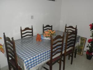 a dining room table with a blue and white checkered table cloth at McCarthy Guesthouse in Kandy