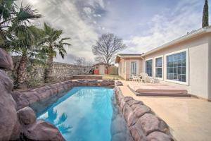 a swimming pool with a retaining wall next to a house at El Paso Home with BBQ Grill - 4 Mi to Sunland Park! in El Paso