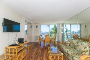 a living room with a couch and a table at Ilikai Marina 382 Yacht Harbor View 1BR in Honolulu