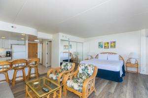 a hotel room with a bed and a dining room at Ilikai Tower 2141 Yacht Harbor View 1BR in Honolulu