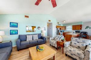 uma sala de estar com um sofá, cadeiras e uma mesa em The Beach House em Gulf Shores