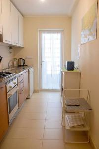 a kitchen with a sink and a refrigerator at Apartamento Margarida Royal Cabanas Golf By Your Home Algarve in Tavira