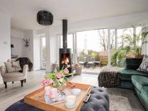 a living room with a couch and a fireplace at Ty Mawr in Menai Bridge