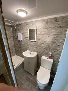 a bathroom with a toilet and a sink at Adorable private suite with free street parking in Leicester