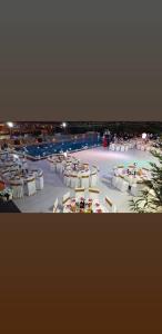 a group of tables and chairs in a large room at Resort Zerja and Spa in Peshkopi