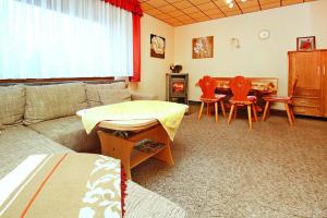 a living room with a couch and a table and chairs at Holiday home, Luebben in Lübben