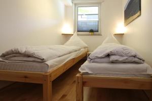 two twin beds in a room with a window at Apartment, Braunlage in Braunlage