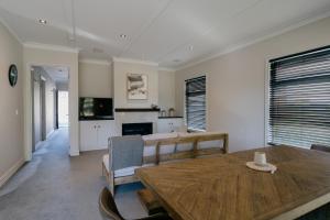 a dining room with a table and a fireplace at Cardrona Valley Escape - Cardrona Holiday Home in Cardrona