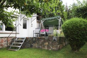 a garden with a rock retaining wall and a table and chairs at Apartment, Sternberg in Sternberg