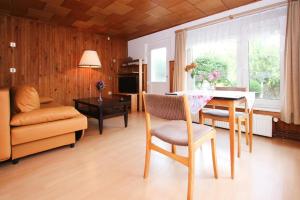 a living room with a table and chairs and a couch at Apartment, Sternberg in Sternberg