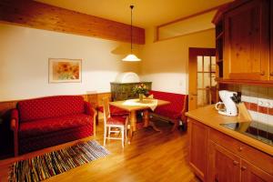 a living room with a red couch and a table at Apartment in Achenkirch near Lake Achensee in Achensee