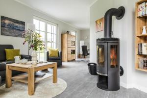 a living room with a wood burning stove at Holiday house, Fuhlendorf in Fuhlendorf