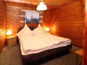 a bedroom with a bed in a wooden room at Blockhouse Spreewald, Alt Zauche in Alt Zauche