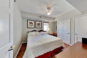 a bedroom with a bed and a ceiling fan at Water Street Condos III in Wilmington