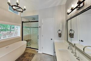 a bathroom with a tub and a sink and a mirror at Young's Mountain Hideaway in Lake Lure +38 photos