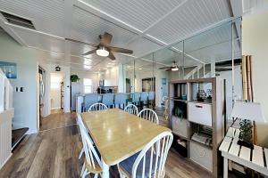 a dining room with a table and chairs at Oceanfront Townhouse in Carolina Beach