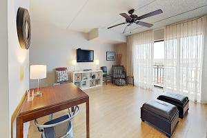 a living room with a desk and a television at River View Condo A in Wilmington