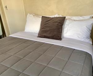 a bed with two pillows on top of it at Comfortable & Close to Town in Twizel