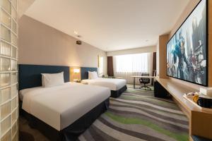 Rúm í herbergi á Holiday Inn Express Jinan High-Tech Zone, an IHG Hotel