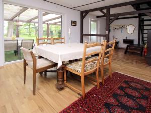 a dining room with a white table and chairs at Holiday home Seeidyll, Teupitz in Teupitz