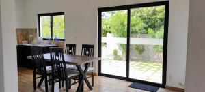 a kitchen and dining room with a table and chairs at Winter Woods in Vagamon