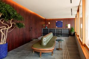 a lobby with a couch and a table in a room at HOTEL AO KAMAKURA in Kamakura