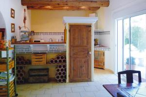 a kitchen with a stove and an open door at Cozy Noves Home with Pool Access in Noves