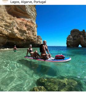 a group of people sitting on a paddle board in the water at Casa de Oksana in Lagos