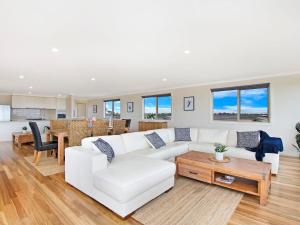 a living room with a white couch and a table at Ocean Mist in Port Fairy