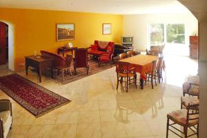 a living room with a table and chairs at Premium villa with garden and private pool, Lambesc in Lambesc