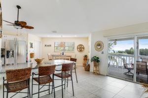 a kitchen and living room with a table and chairs at The Anchor House in Marathon