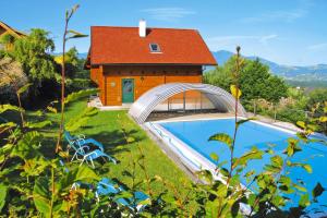 a house with a swimming pool next to a building at Chalet near Kalkalpen National Park in Schlierbach