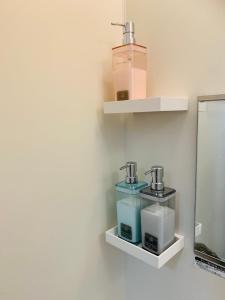 a shelf with two cups on a wall at ゆくい家 in Ginowan