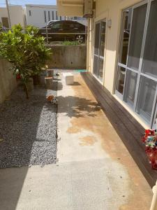 a house being remodeled with a porch and a driveway at ゆくい家 in Ginowan