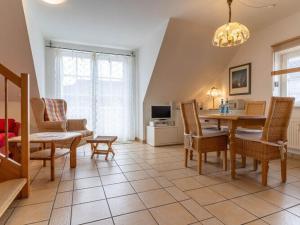 a living room with a dining room table and chairs at Apartment in St Peter-Ording in Süderhöft