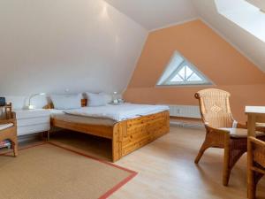 a bedroom with a bed and a table and a window at Apartment in St Peter-Ording in Süderhöft