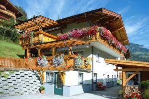 a building with potted plants and flowers on it at Apartments Joe, Grossarl in Grossarl